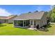 Back of home with enclosed patio and view of lawn at 6465 Royal Pine Dr., Myrtle Beach, SC 29588