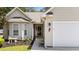 Close up of home's front entrance highlighting walkway, bench seating and fresh landscaping at 6465 Royal Pine Dr., Myrtle Beach, SC 29588