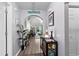 Welcoming gray hallway showcasing wood flooring, art, and entryway into the living room at 6465 Royal Pine Dr., Myrtle Beach, SC 29588