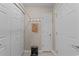 Neutral hallway with multiple white doors, coat hooks, and an adorable decorative sign at 6465 Royal Pine Dr., Myrtle Beach, SC 29588