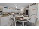 Well-lit kitchen with white cabinets, granite countertops, stainless steel appliances, and a cozy breakfast nook at 6465 Royal Pine Dr., Myrtle Beach, SC 29588