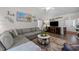 Spacious living room featuring vaulted ceiling, modern furnishings, and lots of natural light at 6465 Royal Pine Dr., Myrtle Beach, SC 29588
