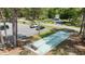 Overhead shot of a recreational area featuring shuffleboard courts, parking, and mature trees at 6465 Royal Pine Dr., Myrtle Beach, SC 29588