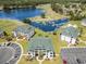 Aerial of condos with golf course view, parking, pond, and verdant landscaping at 673 Tupelo Ln. # G, Longs, SC 29568