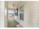 Enclosed balcony with door and green indoor/outdoor carpet, and door art at 673 Tupelo Ln. # G, Longs, SC 29568