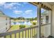 Private balcony overlooking a serene pond and manicured green spaces for peaceful enjoyment at 673 Tupelo Ln. # G, Longs, SC 29568