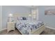 Cozy bedroom features beach-themed decor, light blue walls, and light-colored wood-look flooring at 673 Tupelo Ln. # G, Longs, SC 29568