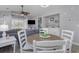 Cozy dining area with wood table, white chairs, and beachy decor in an open floor plan at 673 Tupelo Ln. # G, Longs, SC 29568