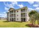 Beautifully maintained condo building featuring multiple screened-in balconies and lush landscaping at 673 Tupelo Ln. # G, Longs, SC 29568
