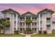 Beautiful condo at sunset with three floors of balconies and tropical palm trees at 673 Tupelo Ln. # G, Longs, SC 29568