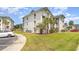 Exterior showcases well-maintained condo buildings, green spaces, and manicured landscaping at 673 Tupelo Ln. # G, Longs, SC 29568