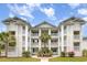 Beautiful condo with three floors of balconies and manicured landscaping featuring tropical palm trees at 673 Tupelo Ln. # G, Longs, SC 29568
