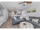 Living room with gray couches, gray walls, and light wood floors at 673 Tupelo Ln. # G, Longs, SC 29568