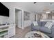 Living room with gray walls, light wood floors, and built in cabinets at 673 Tupelo Ln. # G, Longs, SC 29568