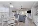 Living room with gray couches, light wood floors, dining table, and built in cabinets at 673 Tupelo Ln. # G, Longs, SC 29568