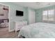 Bright bedroom with a queen bed, coastal decor, a dresser, and a large window at 673 Tupelo Ln. # G, Longs, SC 29568