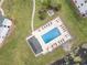 Aerial view of pool, chairs, umbrellas, adjacent to golf course, near trees and ponds at 673 Tupelo Ln. # G, Longs, SC 29568