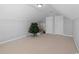 Spacious attic with carpet flooring, neutral paint, and two entry doors at 680 Twinflower St., Little River, SC 29566