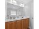 Bathroom features a double vanity with solid surface countertops and wood cabinets at 680 Twinflower St., Little River, SC 29566