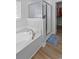 Modern bathroom featuring a soaking tub with a shower and hardwood floors at 680 Twinflower St., Little River, SC 29566