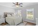Bright bedroom with a queen bed, soft colors, and natural light from two windows at 680 Twinflower St., Little River, SC 29566