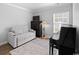 Versatile bedroom with neutral tones, a convertible sofa, and a sleek black piano at 680 Twinflower St., Little River, SC 29566