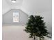 Spacious upper bonus room featuring vaulted ceilings and a large window for natural light at 680 Twinflower St., Little River, SC 29566