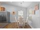 Bright breakfast nook featuring a stainless steel fridge, hardwood floors, and white accents at 680 Twinflower St., Little River, SC 29566