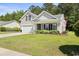Charming home featuring a manicured lawn, classic siding, and an attached two-car garage at 680 Twinflower St., Little River, SC 29566