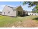 Exterior view of home with lawn, trees, and fenced-in yard at 680 Twinflower St., Little River, SC 29566