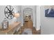 Welcoming foyer with wood floors, console table, and view into the spacious living area at 680 Twinflower St., Little River, SC 29566