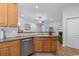 Well-lit kitchen with stainless steel appliances, wooden cabinets, and hardwood floors at 680 Twinflower St., Little River, SC 29566