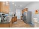 Well-lit kitchen with stainless steel appliances, wood cabinets, and a breakfast area at 680 Twinflower St., Little River, SC 29566