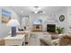 Open living room with fireplace, hardwood floors, beach-themed art and lots of seating at 680 Twinflower St., Little River, SC 29566