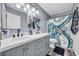 Stylish bathroom featuring dual sinks, a modern vanity, and an octopus-themed shower curtain at 6864 Woodhaven Dr., Myrtle Beach, SC 29588