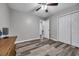 A bright bedroom features hard wood floors, a ceiling fan, and a closet at 6864 Woodhaven Dr., Myrtle Beach, SC 29588