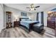 Relaxing bedroom featuring a ceiling fan, wood-look flooring, and dark wood furniture at 6864 Woodhaven Dr., Myrtle Beach, SC 29588