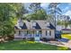 Charming home with a welcoming front porch, lush lawn, and driveway featuring a blue Jeep at 6864 Woodhaven Dr., Myrtle Beach, SC 29588