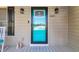 Close-up of the bright blue front door with stylish exterior lighting and decorative accents at 6864 Woodhaven Dr., Myrtle Beach, SC 29588