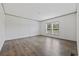 Bedroom featuring wood-look floors and two windows at 7019 Norton Rd., Green Sea, SC 29545