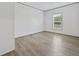 This bedroom offers a light-colored wood look flooring, a window, and light-colored walls and trim at 7019 Norton Rd., Green Sea, SC 29545