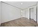 A bright bedroom with light-colored walls, trim, and closet with a light wood-look flooring at 7019 Norton Rd., Green Sea, SC 29545