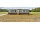 Charming one-story home with green siding, brick foundation, and inviting front steps at 7019 Norton Rd., Green Sea, SC 29545