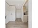 Hallway with light-colored walls, trim, and light wood-look flooring leading to the kitchen at 7019 Norton Rd., Green Sea, SC 29545