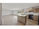 Bright kitchen boasts wood cabinets, a central island, modern appliances, and an adjacent dining area at 7019 Norton Rd., Green Sea, SC 29545
