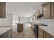 Bright kitchen features wooden cabinets and modern appliances, seamlessly connecting to a spacious living area at 7019 Norton Rd., Green Sea, SC 29545