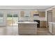 Bright kitchen boasts wood cabinets, a central island, modern appliances, and an adjacent dining area at 7019 Norton Rd., Green Sea, SC 29545