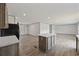 Bright kitchen boasts wooden cabinets, a central island, modern appliances, and an adjacent living area at 7019 Norton Rd., Green Sea, SC 29545