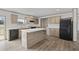 Well-equipped kitchen features wooden cabinets, a center island, and modern appliances, open to dining space at 7019 Norton Rd., Green Sea, SC 29545