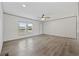 Bright living room features wood-look flooring and a ceiling fan at 7019 Norton Rd., Green Sea, SC 29545